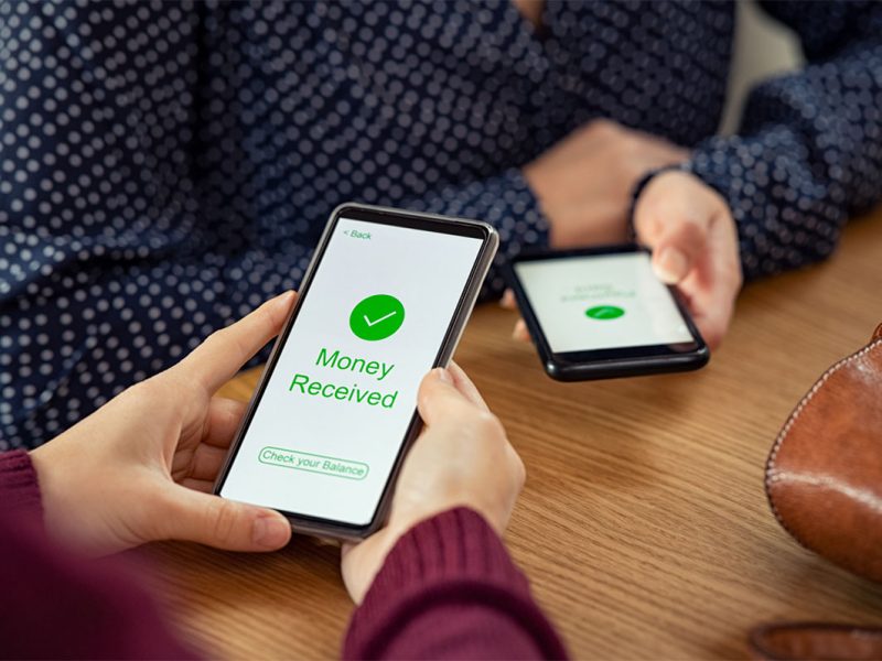 Customers transferring money to each via smartphone