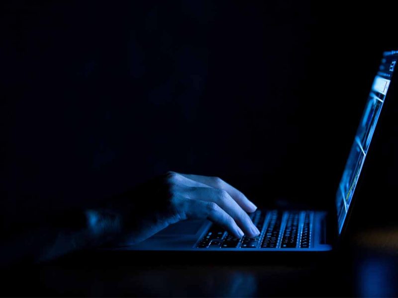 Someone typing on a laptop keyboard