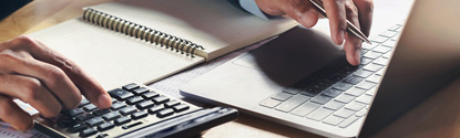businessman working on desk with using calculator and computer in office. concept accounting finance