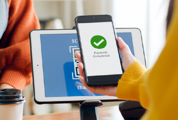 person holding phone to make payment
