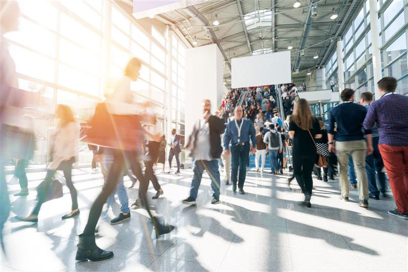 A busy, crowded conference lobby
