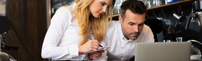 Two restaurant owners working with laptop