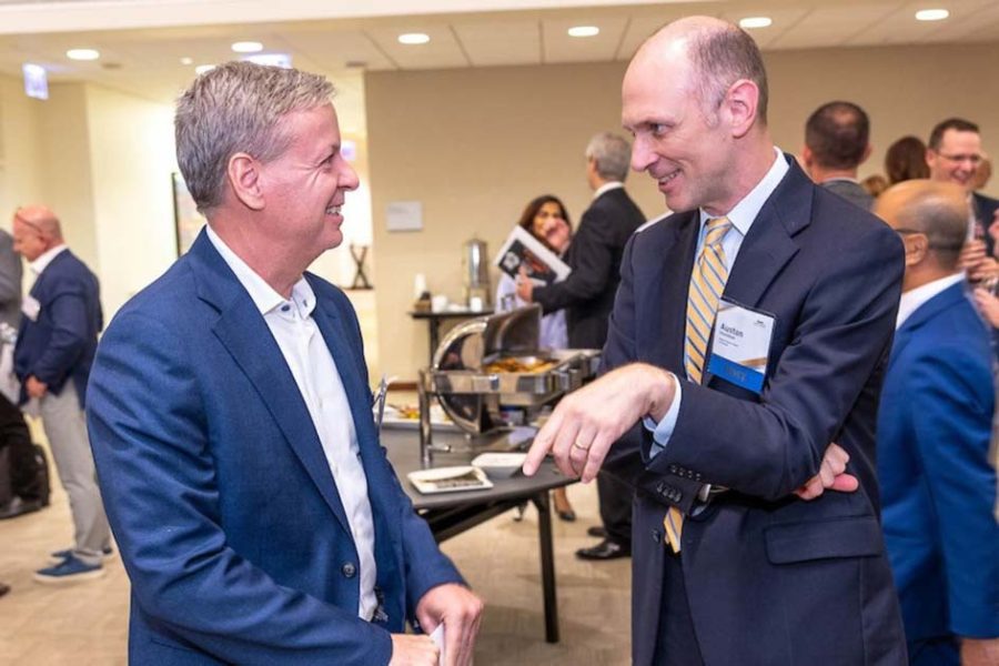Federal Reserve Bank of Chicago CEO Austan Goolsbee (right) networking at the Chicago Payments Symposium reception.