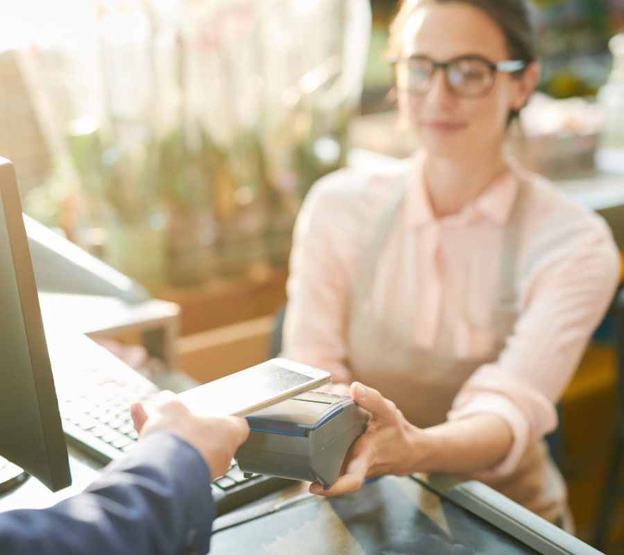 tile-two-instant-payments Person paying with their phone