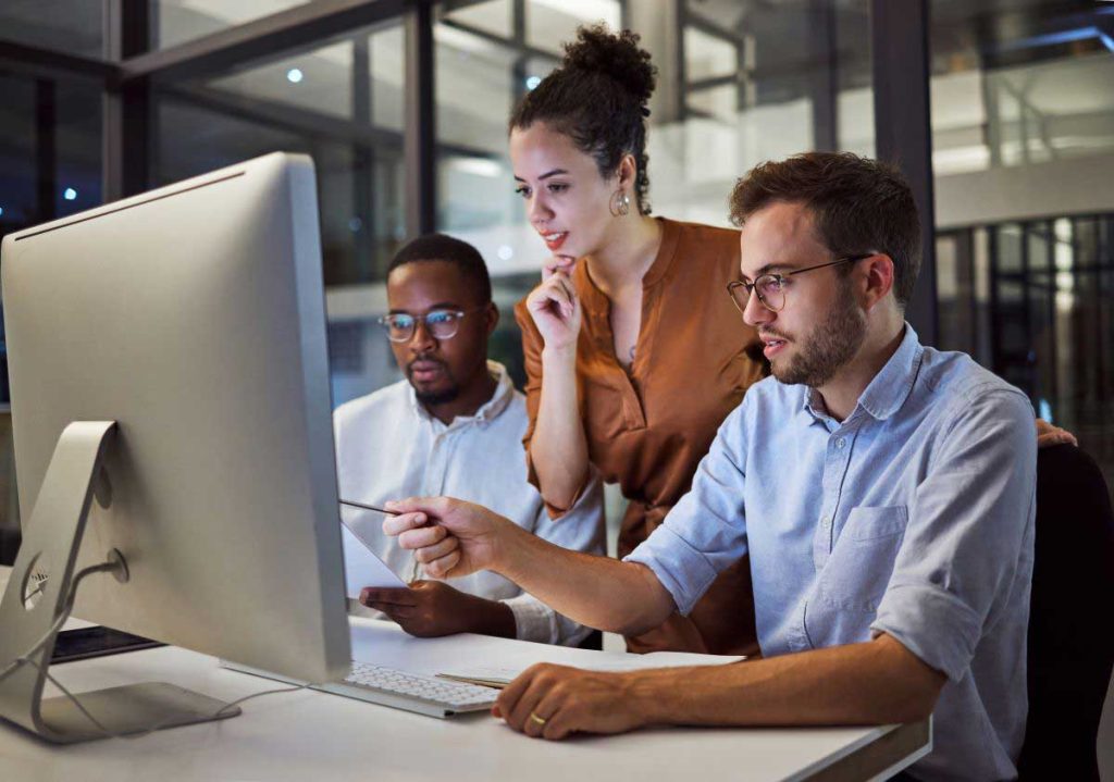 A work group looking at a computer