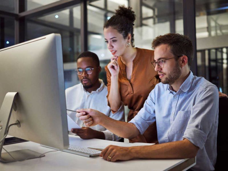 A work group looking at a computer